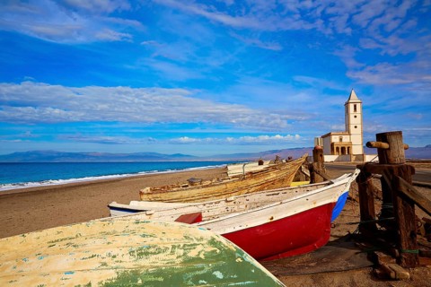 Cabo de Gata in Almeria at San Miguel Beach and Salinas church with stranded boats
