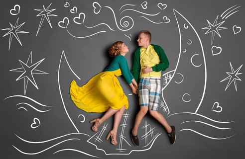 Happy valentines love story concept of a romantic couple swimming on the moon boat, holding hands
