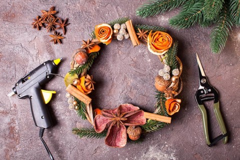 Christmas aromatic eco wreath with dry orange and anise stars, decorated tangerine peel roses,