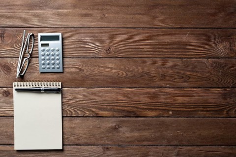 Still life of accountant workspace with office accessories. Flat lay wooden desk with elegant