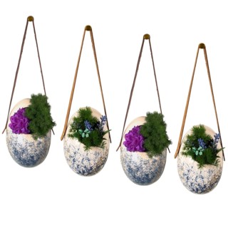 Four hanging planters with speckled design filled with flowers showcasing artistic decor
