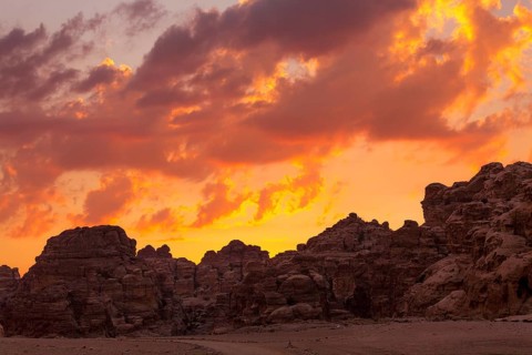 Sunset colorful orange sky landscape with sandstone rocks in Little Petra archaeological site,