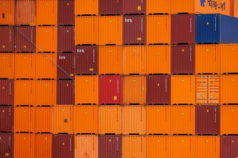 Close up view of stacked orange and red containers in a harbour, rotterdam, the netherlands