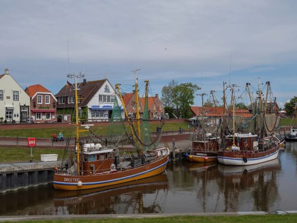 Fishing boats are anchored in the harbour, in the background houses and a maritime atmosphere,