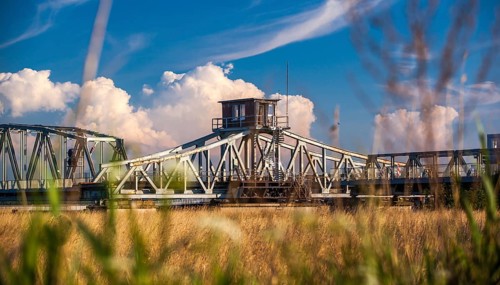 Rusty historic swing bridge with a small driver's cab on the roof