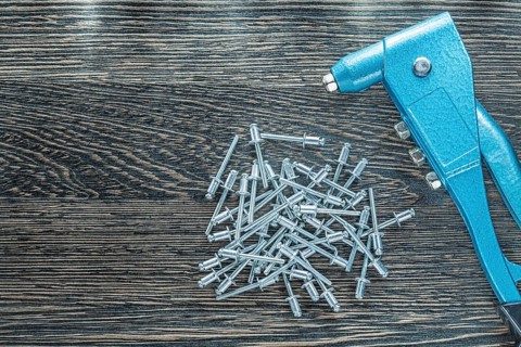 Riveting pliers stainless screws on wooden board