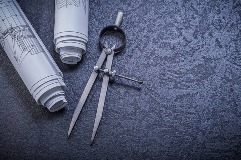 Construction plans pair of compasses on black background maintenance concept