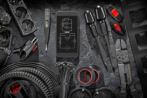 Electric Tools Set With Blueprint On Smartphone Display On Black Stone Background