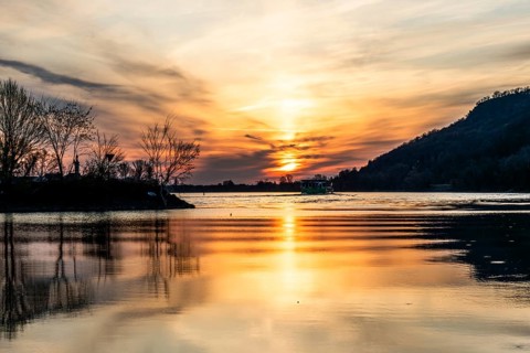 Morning atmosphere on the river, cruise ship on the Danube, near Rossatz, golden hour at sunrise,