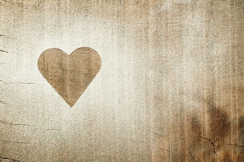 Heart pattern on an old wooden board. Heart made of sugar