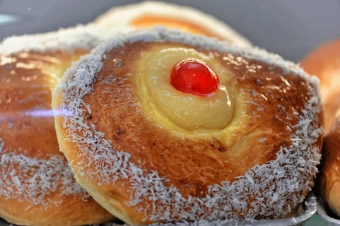 Cadiz, Province of Cadiz, Andalusia, Spain, Europe, Sweet pastry with coconut edge and red cherry