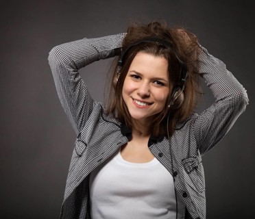 Portrait of the brunette beauty smiling girl wearing headphones