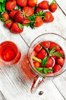 Glass decanter with delicious strawberry compote of fresh berries