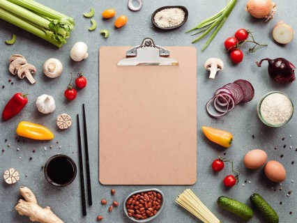 Asian ingredients and empty clipboard. Various of Chinese cooking ingredients and chopsticks on