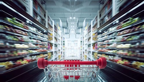 Red shopping cart with motion speed blurred supermarket aisle background