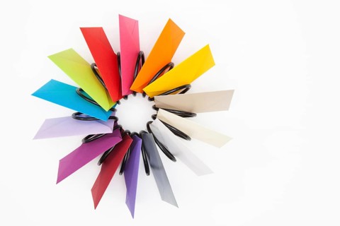 Propeller of colored envelopes on the white table