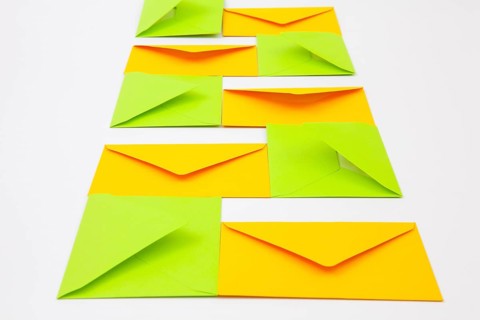 Composition with yellow and green envelopes on the white table