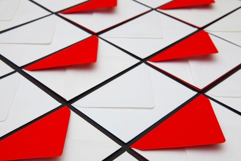 Composition with white and red envelopes on the table. The photo suitable for various holidays and