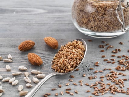 Homemade LSA mix in spoon - Linseed or flax seeds, Sunflower seeds and Almonds. Traditional