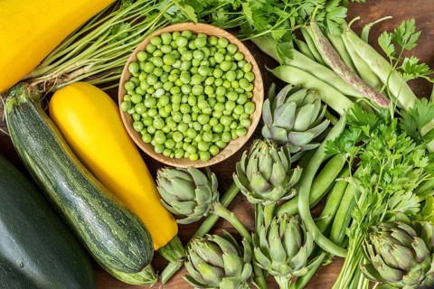 Fresh organic green vegetables wooden floor with copy space. Green and yellow vegetables background