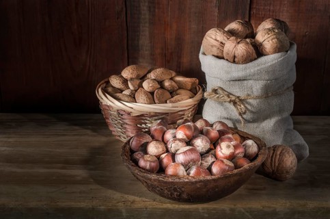 Walnuts on a dark wooden background in a rustic style