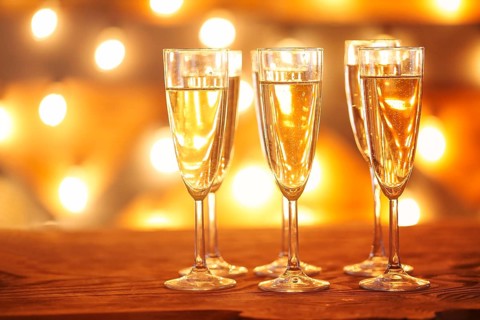 Champagne glasses on golden background. Party and celebration concept