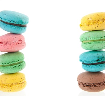 Cadre of stacked colorful macaroons isolated white background