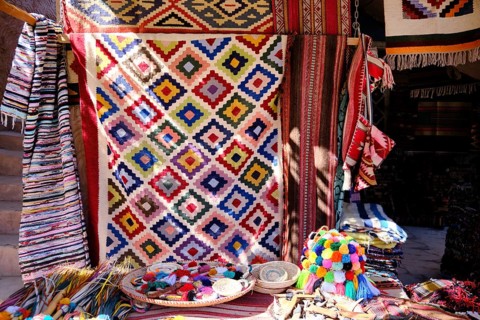 Traditional colorful berber hand woven wool carpets and rugs at middle eastern bazaar. Berber