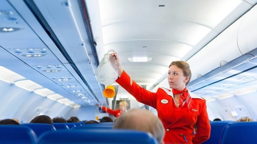 MOSCOW - MAY 28, 2011: Air hostess Yulia of Aeroflot shows how to use an oxygen mask on board.
