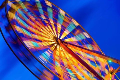 Turning illuminated ferris wheel shot at long exposure
