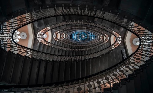 Eye-catching image with staircase design in a spiral form, a pattern of oval figures, illuminated