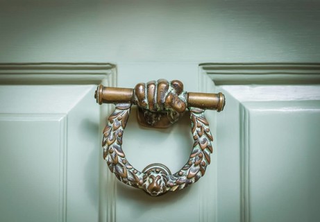 Ornate Brass Door Knocker On A Mint Green Door In Middle England