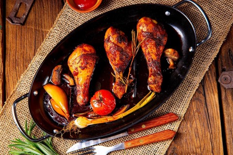 Grilled chicken legs in a barbecue marinade with sweet potatoes