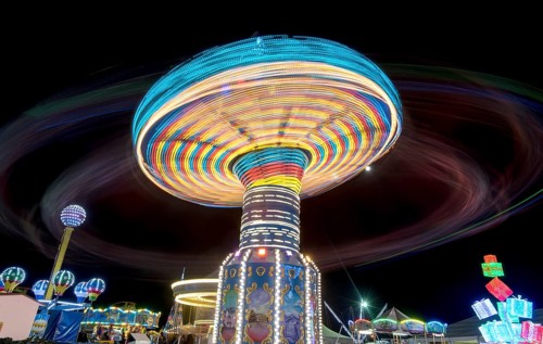 Merry go round, Carousel spinning fast creating wonderful light trails at an amusement park