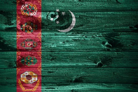 Turkmenistan flag on wooden planks background wood flag