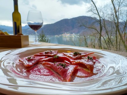 Restaurant Table with Beetroot Ravioli on a White Plate with Mountain View in Switzerland.