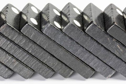 Composition of lying black domino bricks with white dots