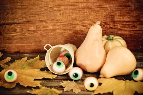 Halloween sweets, autumn leaves and pumpkins for Halloween party