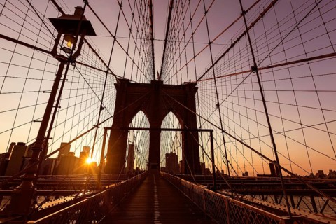 Brooklyn Bridge sunset with Manhattan skyline of New York City USA
