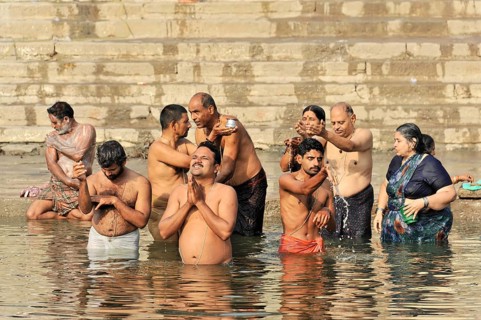 Varanasi, Uttar Pradesh, India, Asia, A group of people perform spiritual rituals in a river, in a