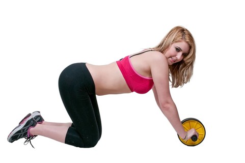 Beautiful woman using an ab wheel