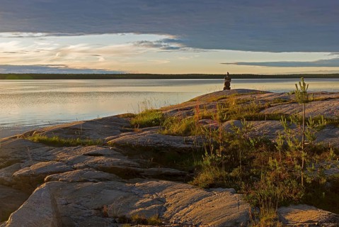 Evening on the White Sea. Stone pillar on coastal granite rock. Kandalaksha Gulf, Karelia, Russia,