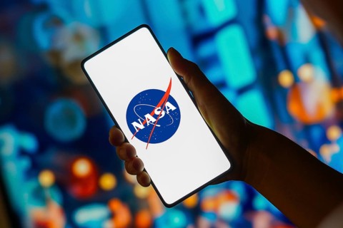 In this photo illustration, the NASA (National Aeronautics and Space Administration) logo is
