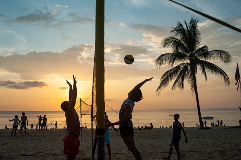 18.11.2019, Phuket, Thailand, Asia, A group of locals playing volleyball on Karon Beach at sunset,