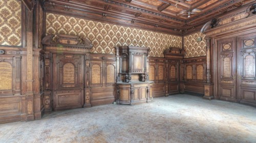 Vacant wooden room with complex pattern and beautiful stucco ceiling, traces of abandonment, Villa