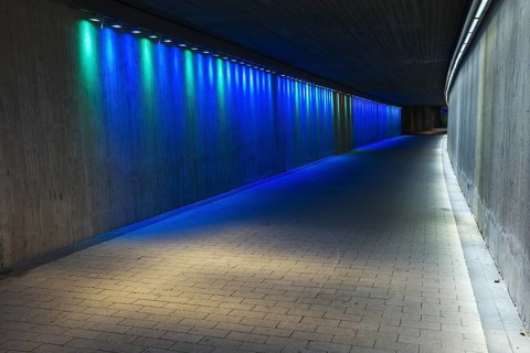 Empty underground concrete tunnel with colorful lighting