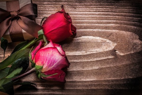 Red roses giftbox on wooden board holidays concept