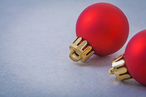 Red christmas balls on gray background with copyspace