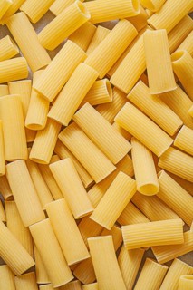 Short-cut uncooked pasta backdrop food and drink concept