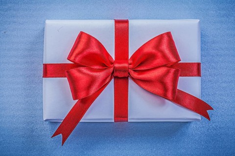 Present on blue background close up view holidays concept